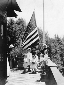 James Leahy on porch with neighborhood children. Likely 4th of July 1909/1910.